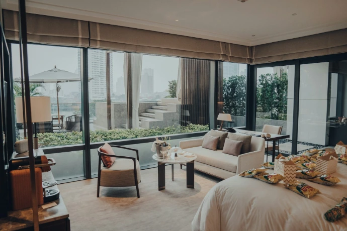 a living area with a couch, chair, table, and windows